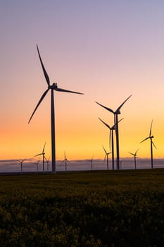 General view of wind turbines in countryside landscape during sunset. environment, sustainability, ecology, renewable energy, global warming and climate change awareness.