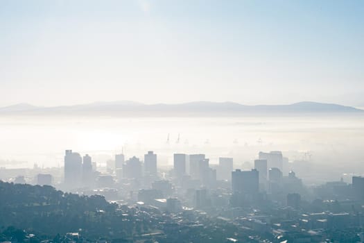 General view of cityscape with multiple modern buildings and skyscrapers in the foggy morning. skyline and urban architecture.