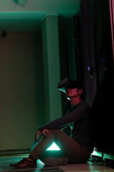 Asian man wearing vr headset while sitting in computer server room. database server and futuristic technology concept