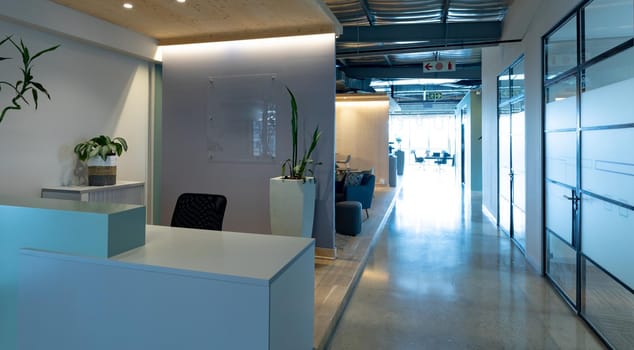 Empty chair at reception counter in modern illuminated office. business, modern office interior and workplace.