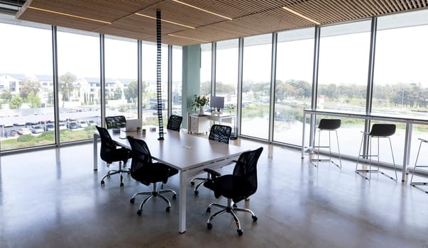 Empty black swivel chairs arranged around desk in modern office. workplace, modern office and business.