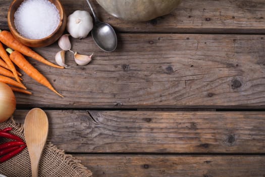 Close up of multiple food ingredients and cutlery with copy space on wooden surface. food and restaurant concept