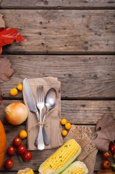 Close up of multiple food ingredients and cutlery with copy space on wooden surface. food and restaurant concept