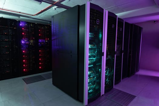 Data center with multiple rows of fully operational server racks. modern cloud computing technology concept.