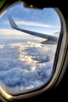 Clouds and sky as seen through window of an aircraft