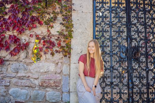 Woman tourist on background of beautiful view of the island of St. Stephen, Sveti Stefan on the Budva Riviera, Budva, Montenegro. Travel to Montenegro concept.