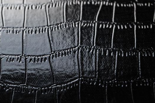 Texture of black crocodile skin in the background in full screen