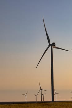 General view of wind turbines in countryside landscape with cloudless sky. environment, sustainability, ecology, renewable energy, global warming and climate change awareness.