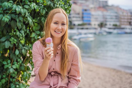 Close up of pretty tourist girl eating traditional gelato italian ice cream in a European town.