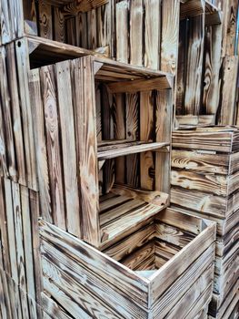 Stack of vintage wooden crates in a shelf for sale in a shop