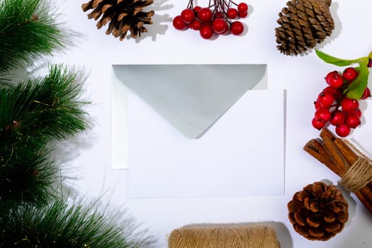 Composition of envelopes with copy space and christmas decorations on white background. christmas, tradition and celebration concept.