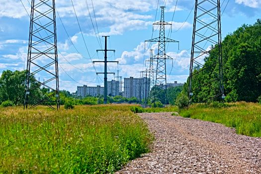 A long line of electrical transmission towers carrying high voltage lines.