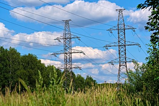 A long line of electrical transmission towers carrying high voltage lines.