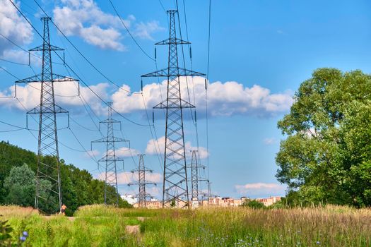 A long line of electrical transmission towers carrying high voltage lines.