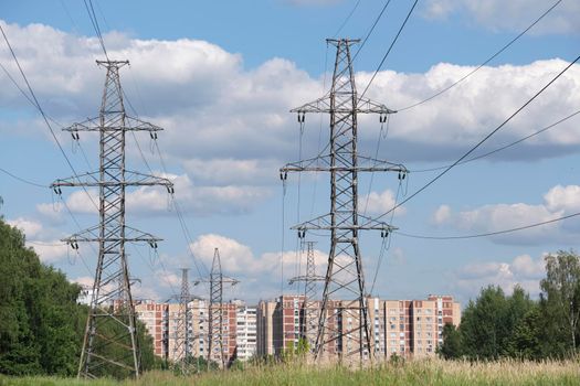 A long line of electrical transmission towers carrying high voltage lines.