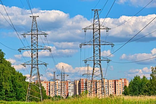 A long line of electrical transmission towers carrying high voltage lines.