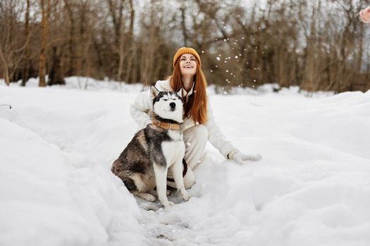 woman with a purebred dog winter landscape walk friendship winter holidays. High quality photo