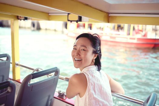 Cropped portrait of an attractive young woman exploring the city alone on a ferry during the day.