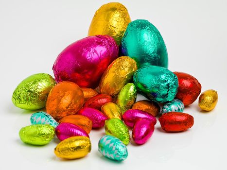 Studio shot of a dazzling array of multicolored easter eggs wrapped in foil.