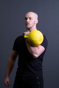 Guy with a yellow kettlebell gym anonymous yellow strength, from motivation lifestyle for men and floor sportswear, southeast activity. Guy down health, circuit hiit