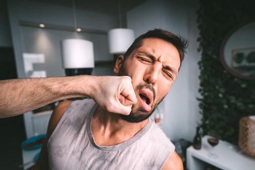 Man takes hard punch in the face. Two man fighting. Man hitting man in the face with fist. Conflict and violence. High quality photo