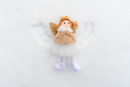 angel with wings in the snow top view. photo
