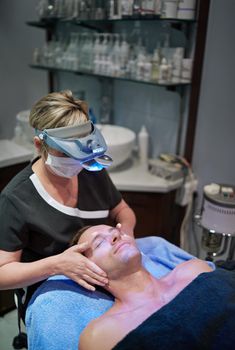 Shot of a man getting a facial treatment at a beauty clinic.