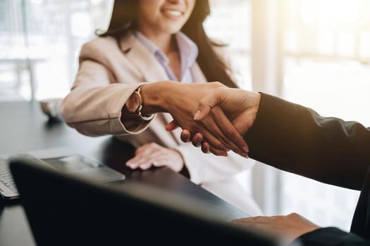 Close up of asian business people shaking hand, finishing up meeting, business etiquette, congratulation, merger and acquisition concept