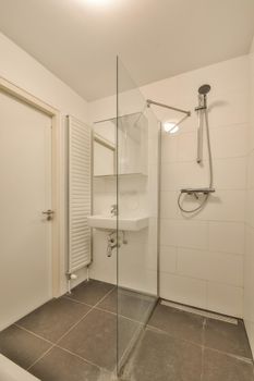 The interior of the bathroom of a modern house with a shower and sink