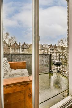 View of the old balcony with sofa and mesh fence