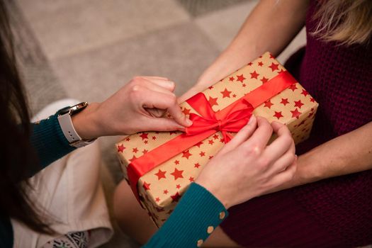 Preparing gifts together during Christmas in Poland. A woman's delicate hands.