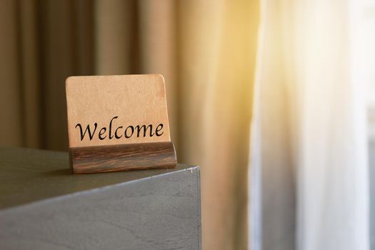 welcome sign on table with sun