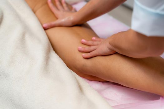 Facial massage. A woman is given a massage in a beauty salon. Close-up