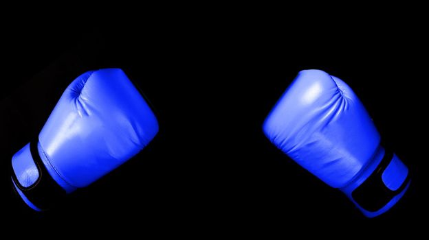 versus Boxing glove in punching  in black background with copy space