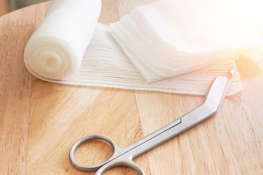 Dressing or clean wound tools includes Roll gauze,pile of gauzes and gauze roll cutter or scissors with sun flare