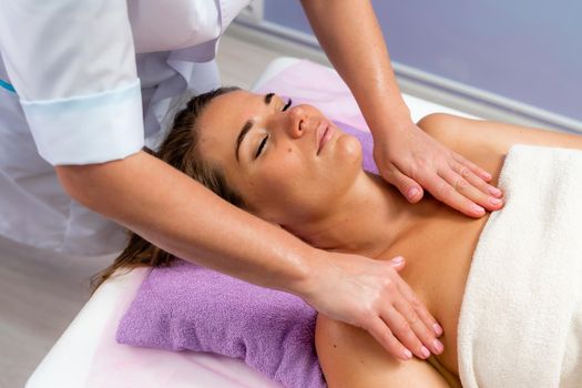 Facial massage. A woman is given a massage in a beauty salon. Close-up.