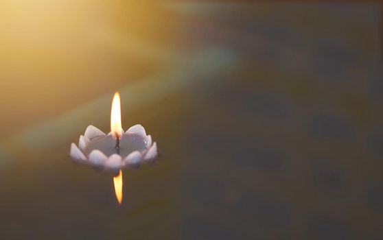 candle floats in water for hope concept