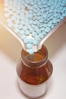 pour pills in bottle in medicine drug tablet in pharmacy