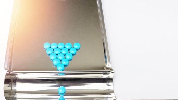 blue pill on pharmacy tray