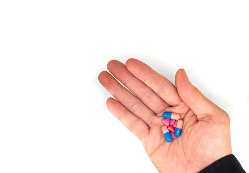 hand hold pills in palm isolated on white