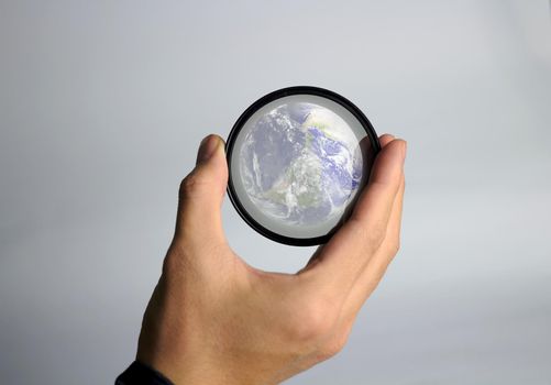 hand hold earth globe planet with glass for environment