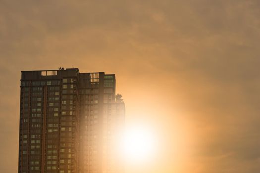 tall building on dawn sky background with sunlight