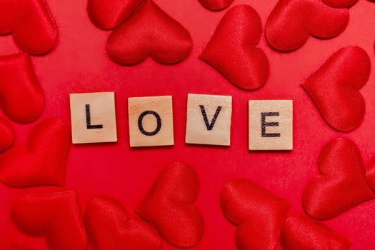 Top view of the inscription with the word love on a red background. Love concept, valentine's day