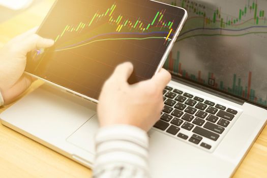 graph in computer and mobile show finance business and stock market volatility