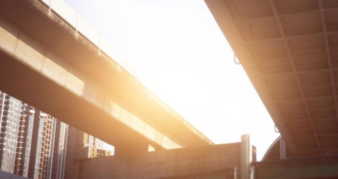 low angle view of highway overpass with sun
