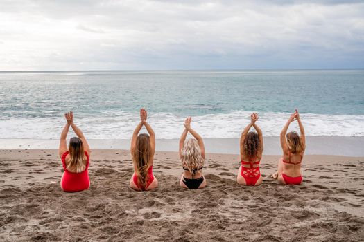 Big happy family or group of five friends is having fun against sunset beach. Beach holidays concept