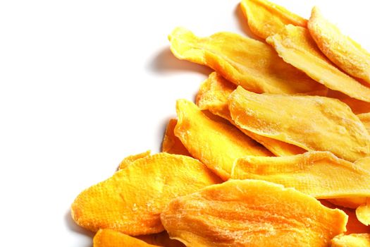 Ripe dried mango sliced on a white background with free space