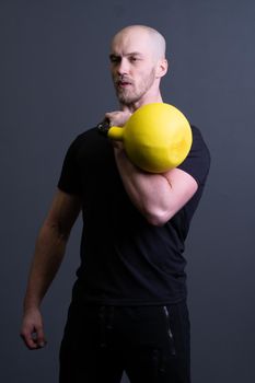 Guy with a yellow kettlebell gym anonymous workout strength, for motivation effort for picking from rubber youth, southeast activity. Healthy bent health, club hiit