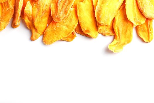 Ripe dried mango sliced on a white background with free space