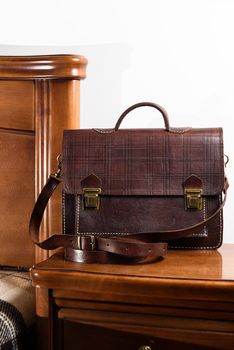 Brown leather briefcase in a cell with two locks. hotel room photo.